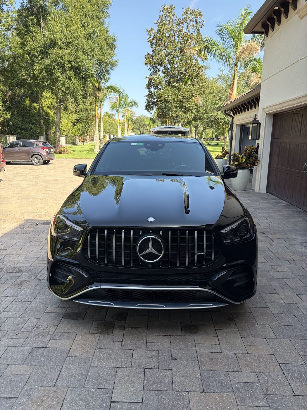 Black Mercedes-AMG GLE front view in a driveway