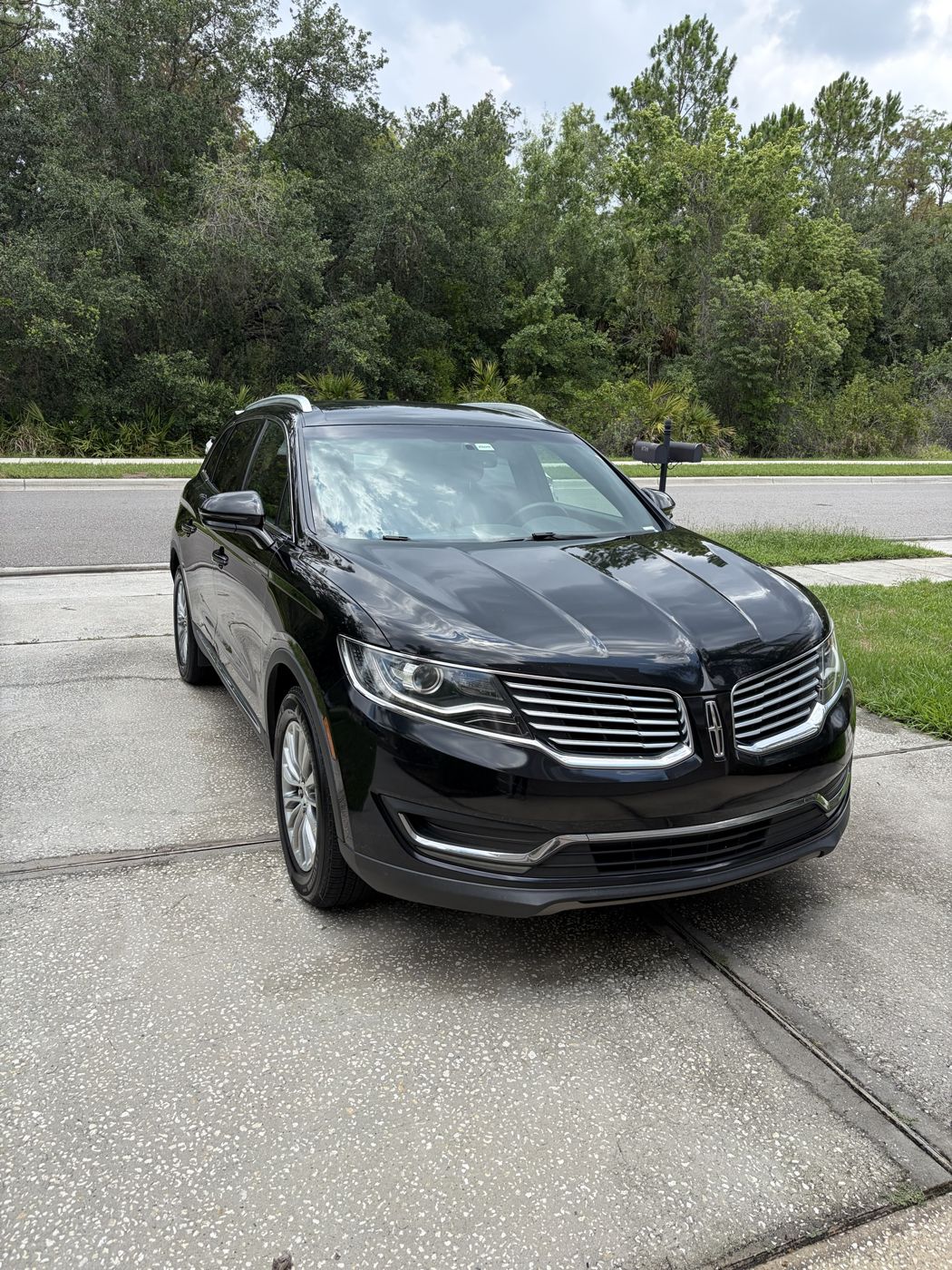 Black Lincoln MKX after a mobile detail in a driveway
