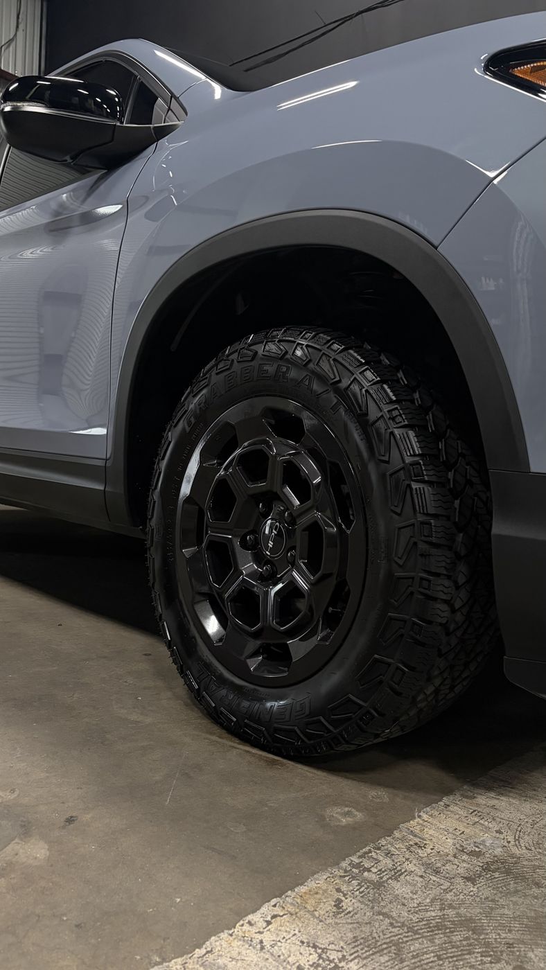 Honda Ridgeline TrailSport black wheel and General Grabber tire